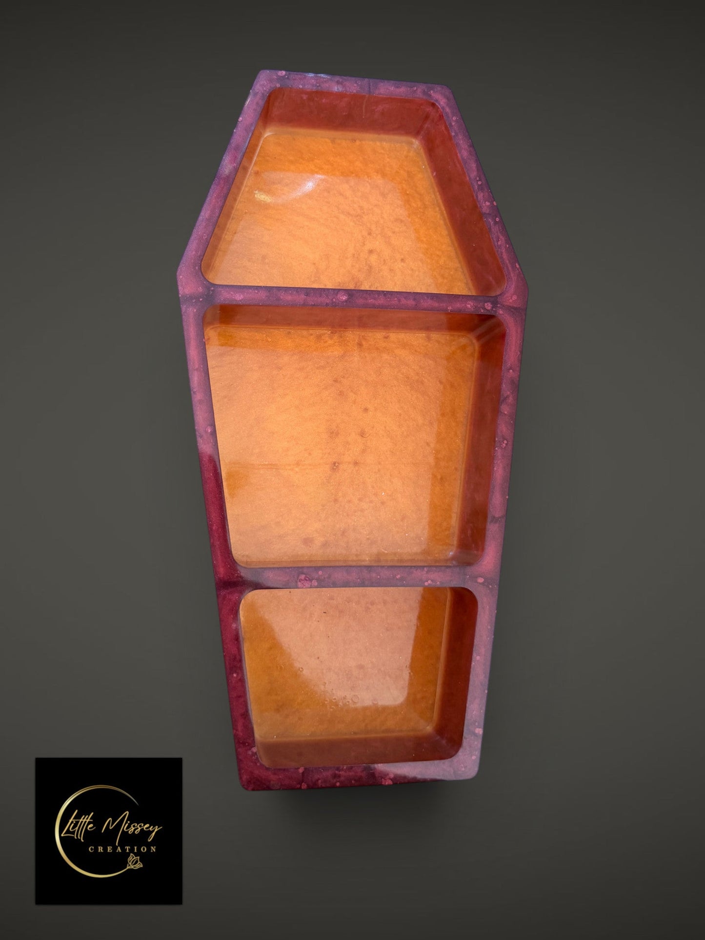 Little Missey Creation coffin-shaped resin trinket tray with a deep purple frame and shimmering orange interior