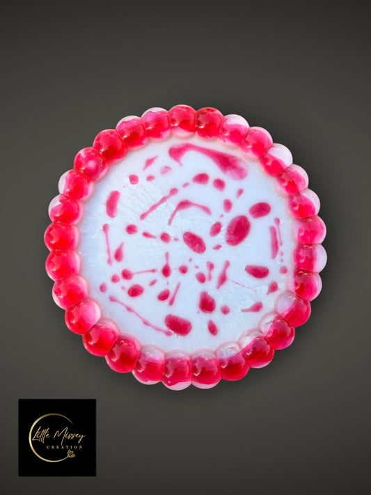 Little Missey Creation round resin tray with a white base, pink beaded edge, and abstract pink swirl design.