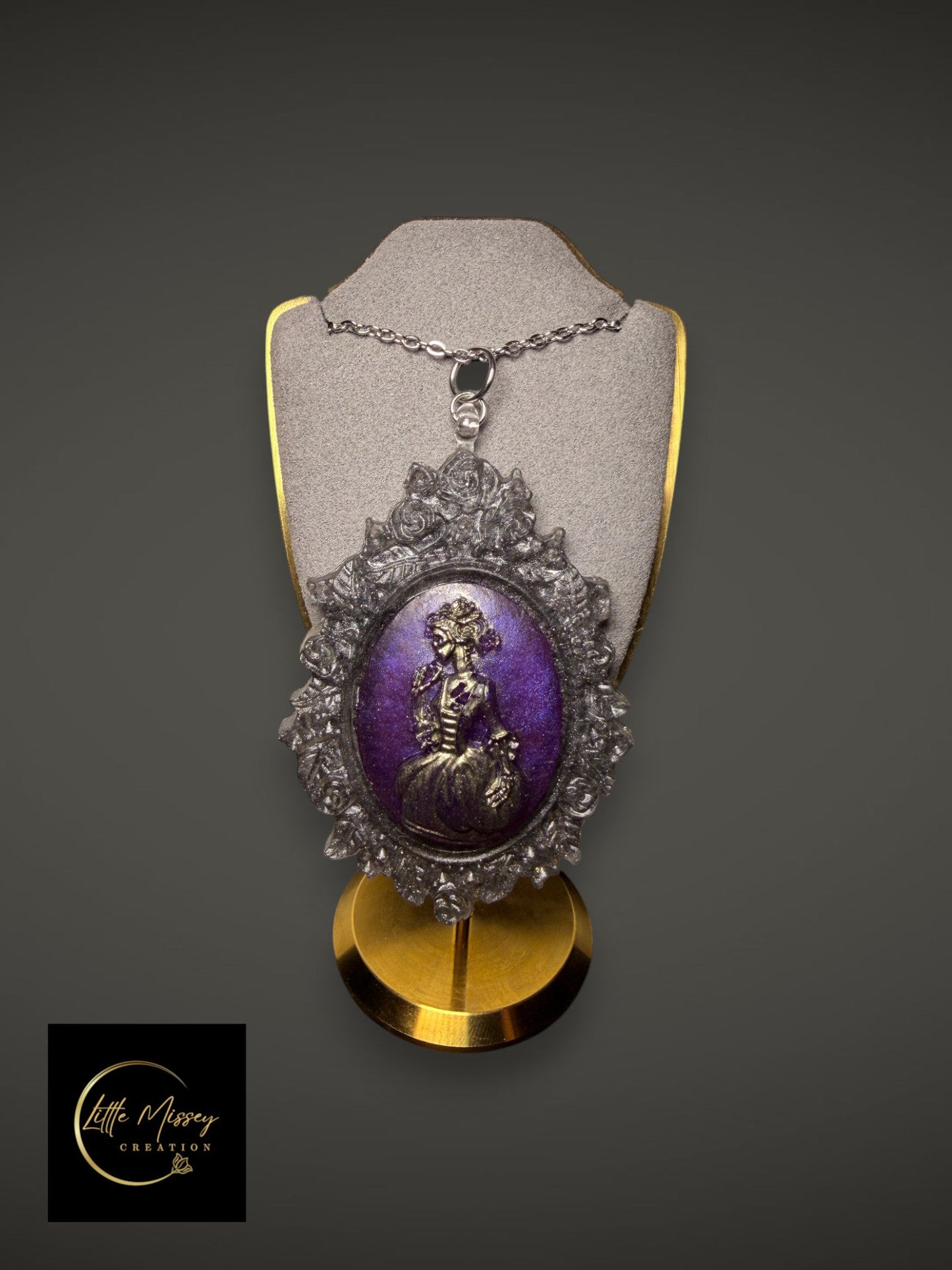 Little Missey Creation ornate Victorian style cameo pendant necklace with a purple shimmering inlay and floral frame.