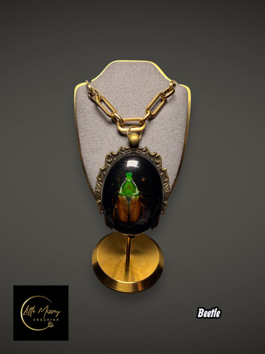 Little Missey Creation beetle pendant necklace featuring an iridescent green beetle in resin with antique bronze frame.