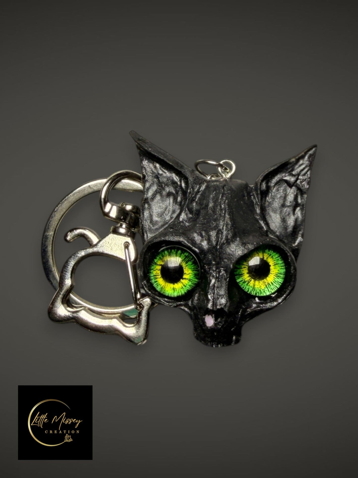 Little Missey Creation black fantasy cat keychain with vibrant green lifelike eyes and a cat-shaped metal clasp