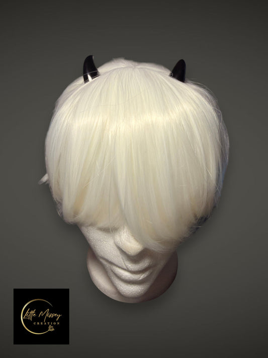 Little Missey Creation black glossy demon horns attached to a short white cosplay wig on a mannequin head