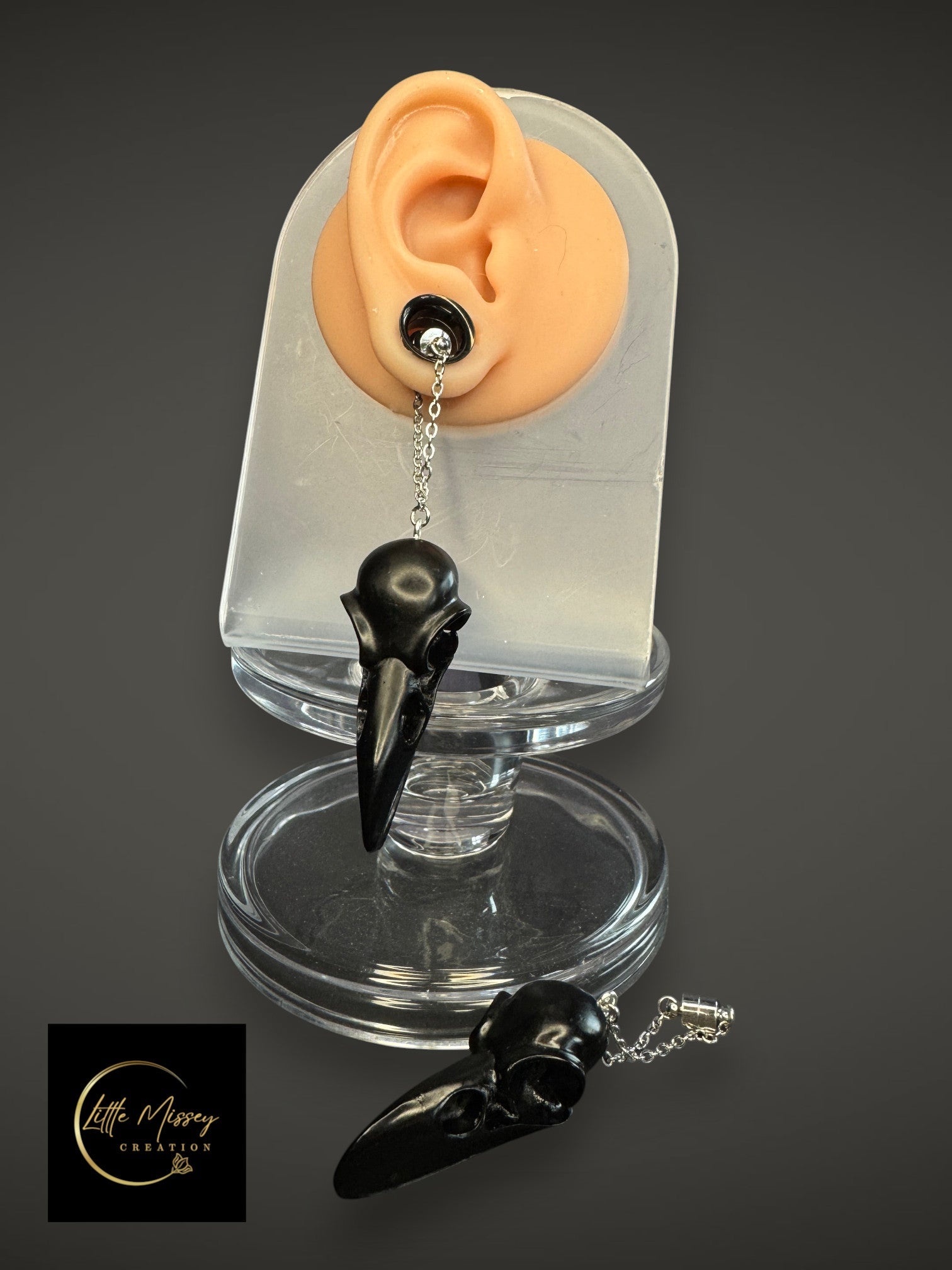 Resin raven skull dangle earrings adapted for those who wear gauges.