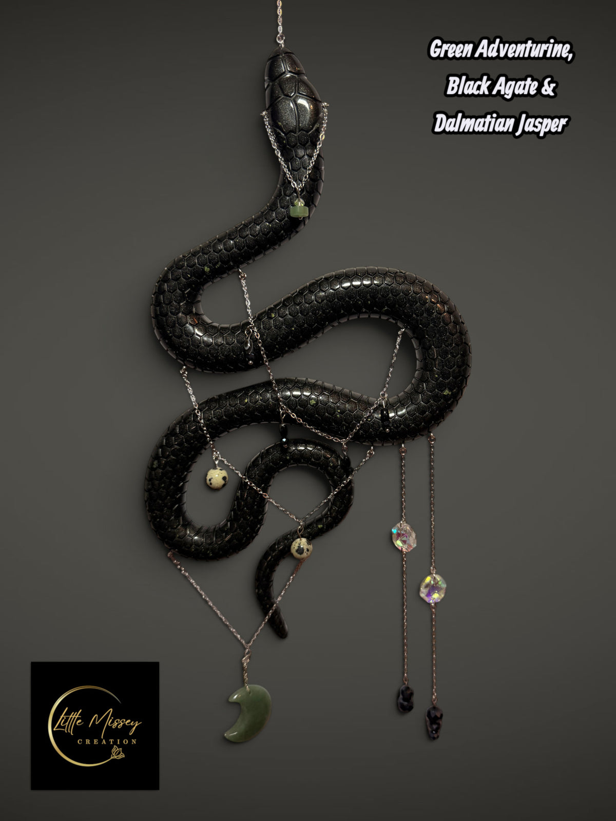 Little Missey Creation handmade black resin serpent wall hanging adorned with silver chains and healing crystals.