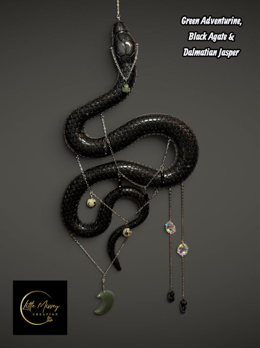 Little Missey Creation handmade black resin serpent wall hanging adorned with silver chains and healing crystals.