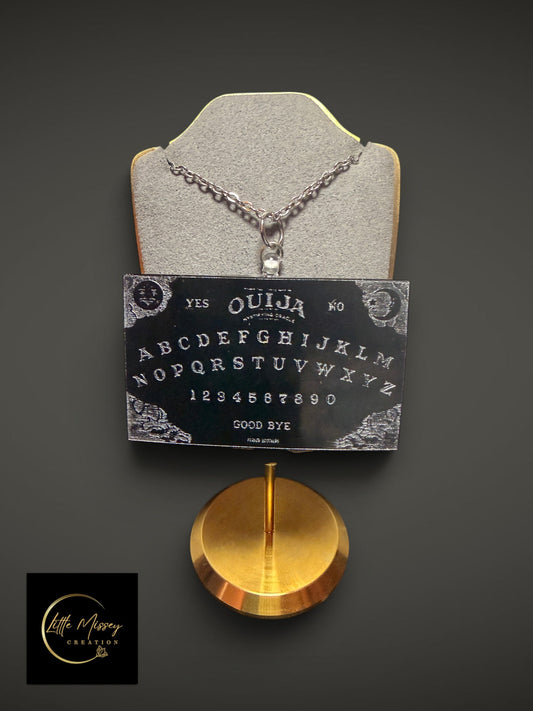 Little Missey Creation black spirit board pendant necklace with silver chain on a grey display stand.
