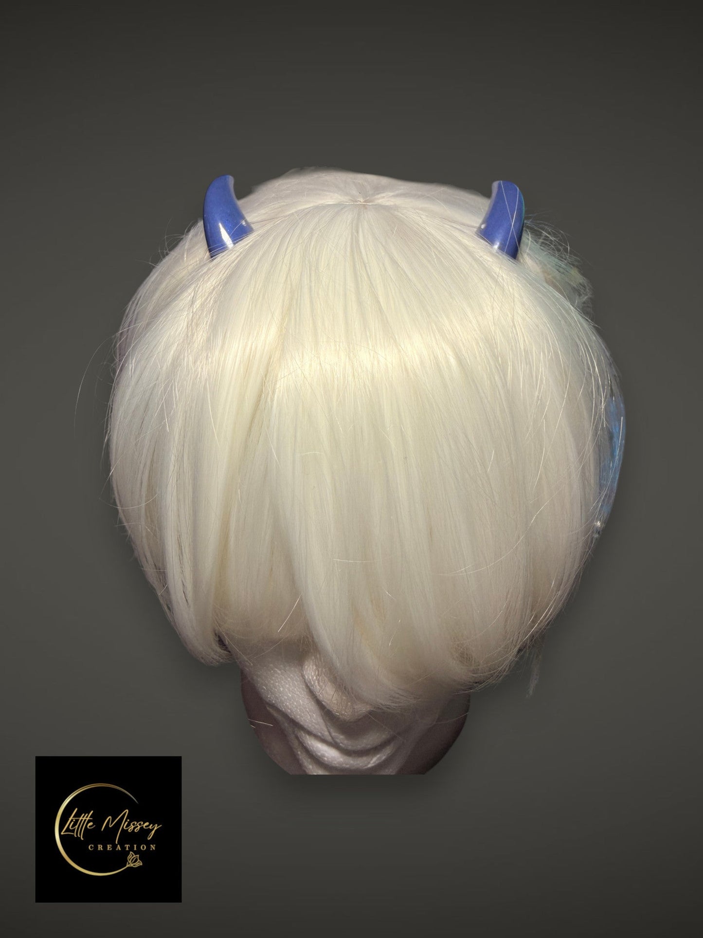 Little Missey Creation glossy blue demon horns worn on a white bob wig for cosplay character transformation