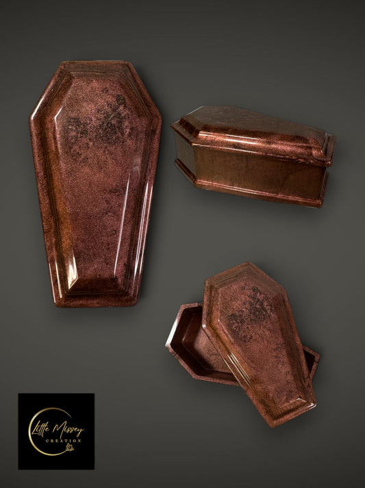 Little Missey Creation coffin-shaped resin trinket box in a shimmering dark copper finish, shown from multiple angles.
