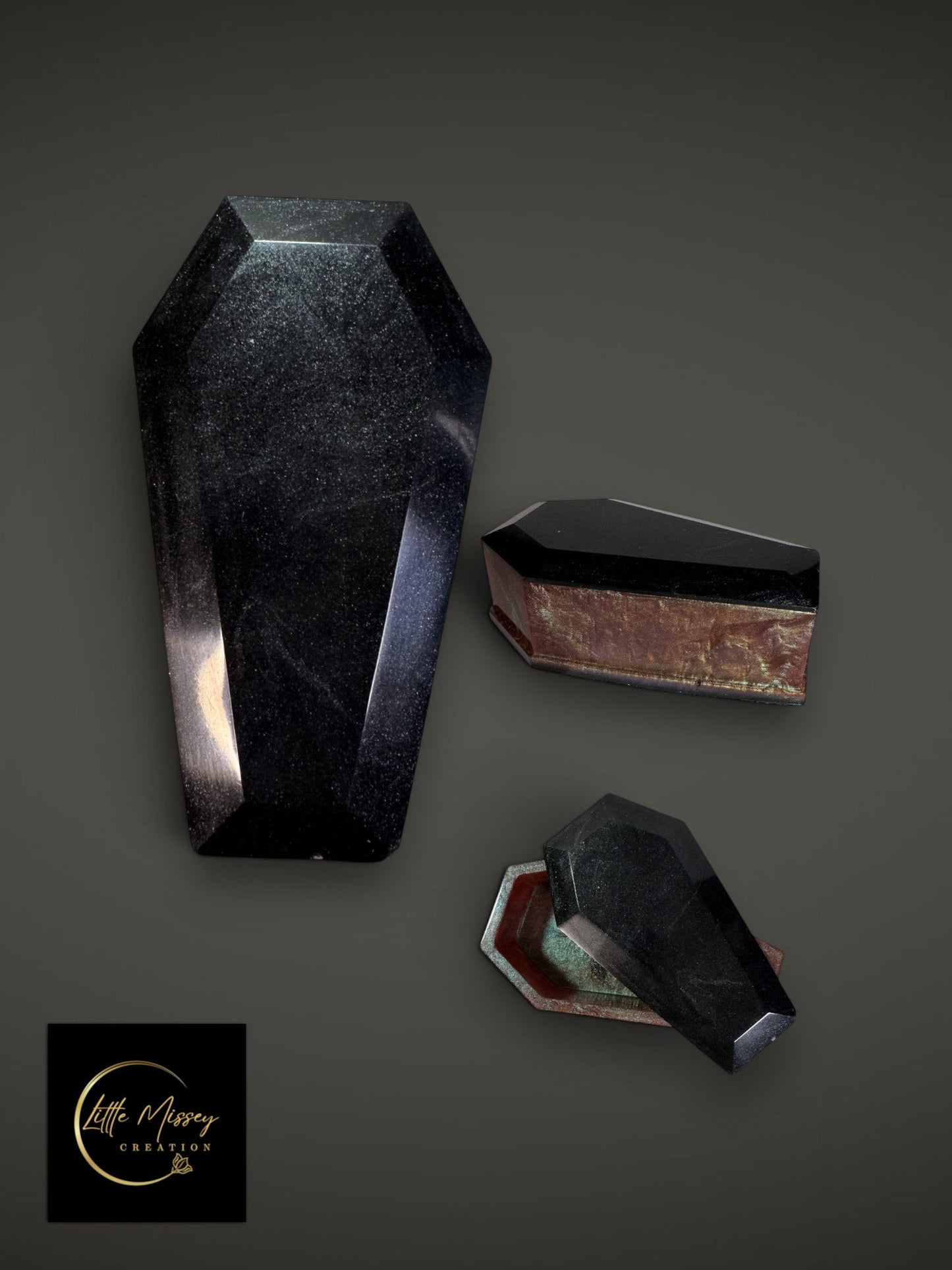 Little Missey Creation coffin trinket boxes in black resin with glitter finish and metallic interior accents.