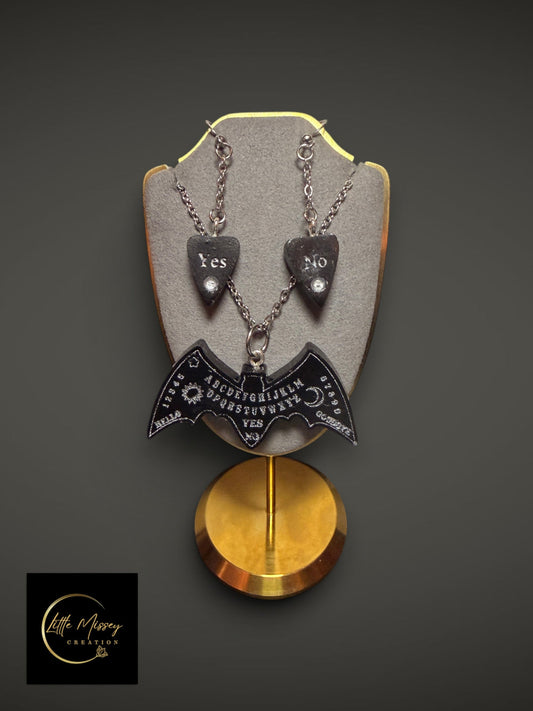 Little Missey Creation gothic spirit board bat necklace and planchette earrings set in black resin on a display stand