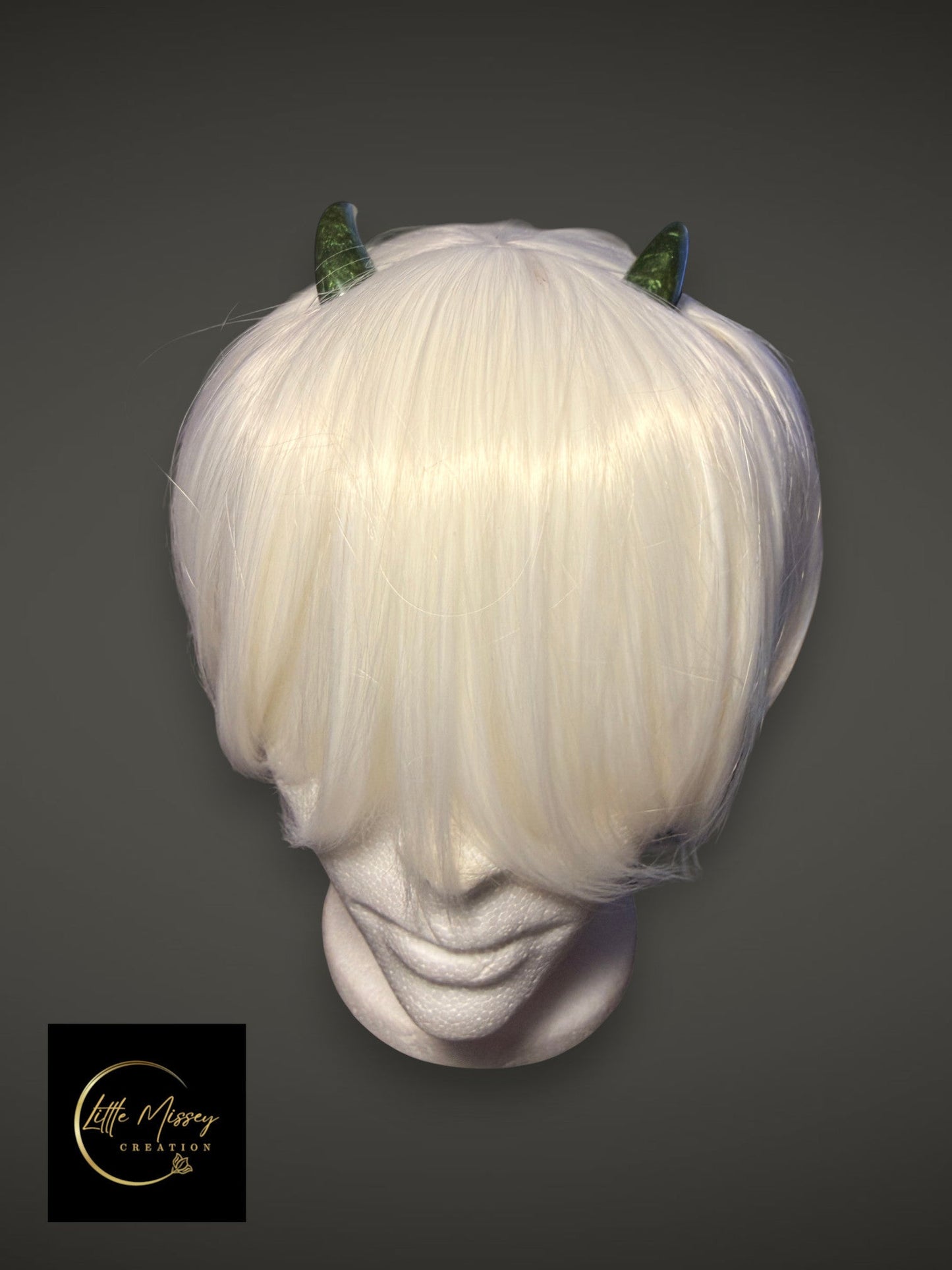 Little Missey Creation handcrafted green marbled demon horns worn on a white bob wig for cosplay character styling