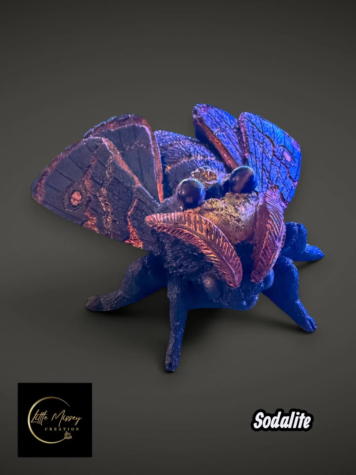 Little Missey Creation handpainted moth figurine in deep blue with shimmering metallic copper wing accents