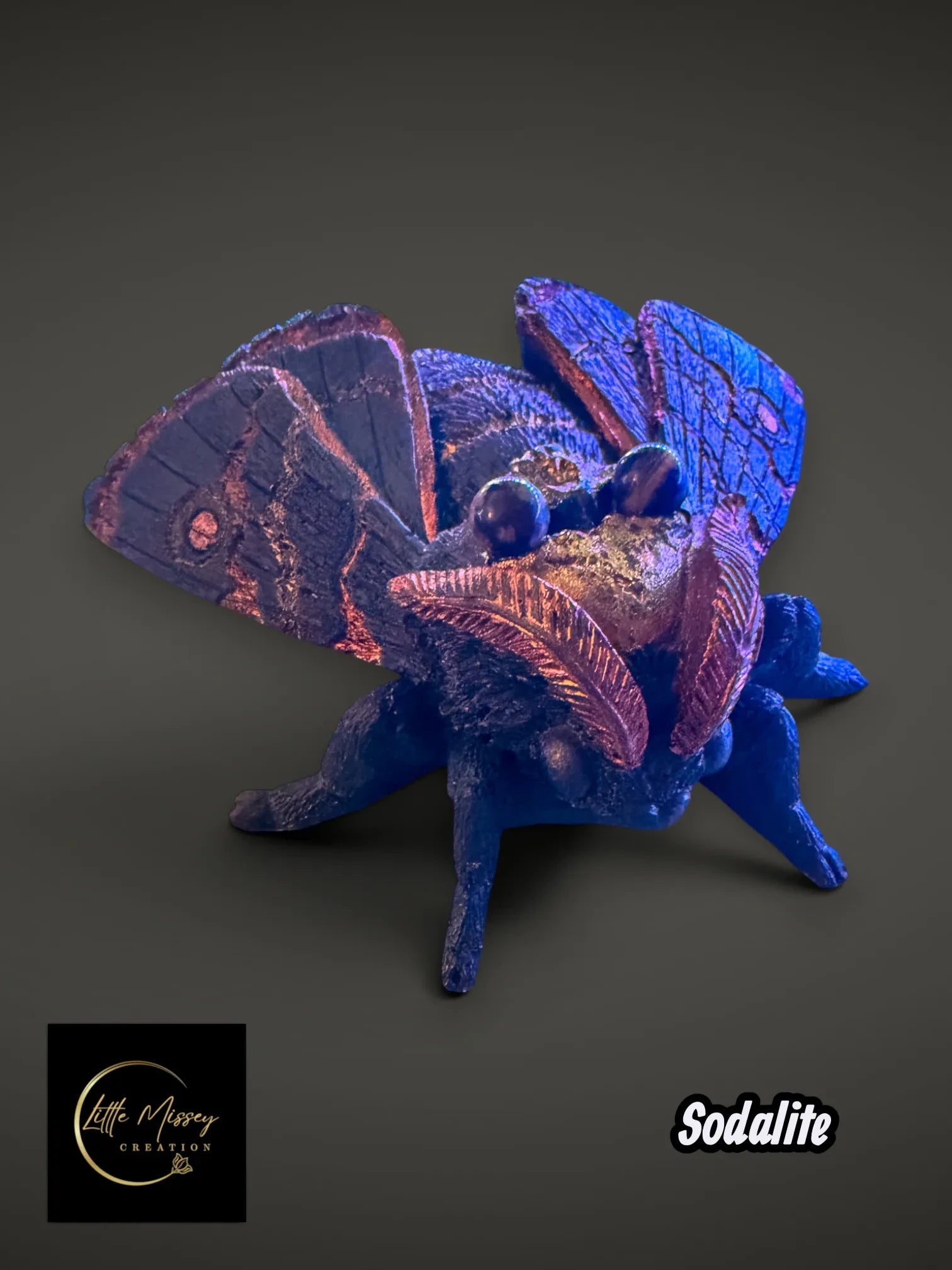 Little Missey Creation handpainted moth figurine in deep blue with shimmering metallic copper wing accents