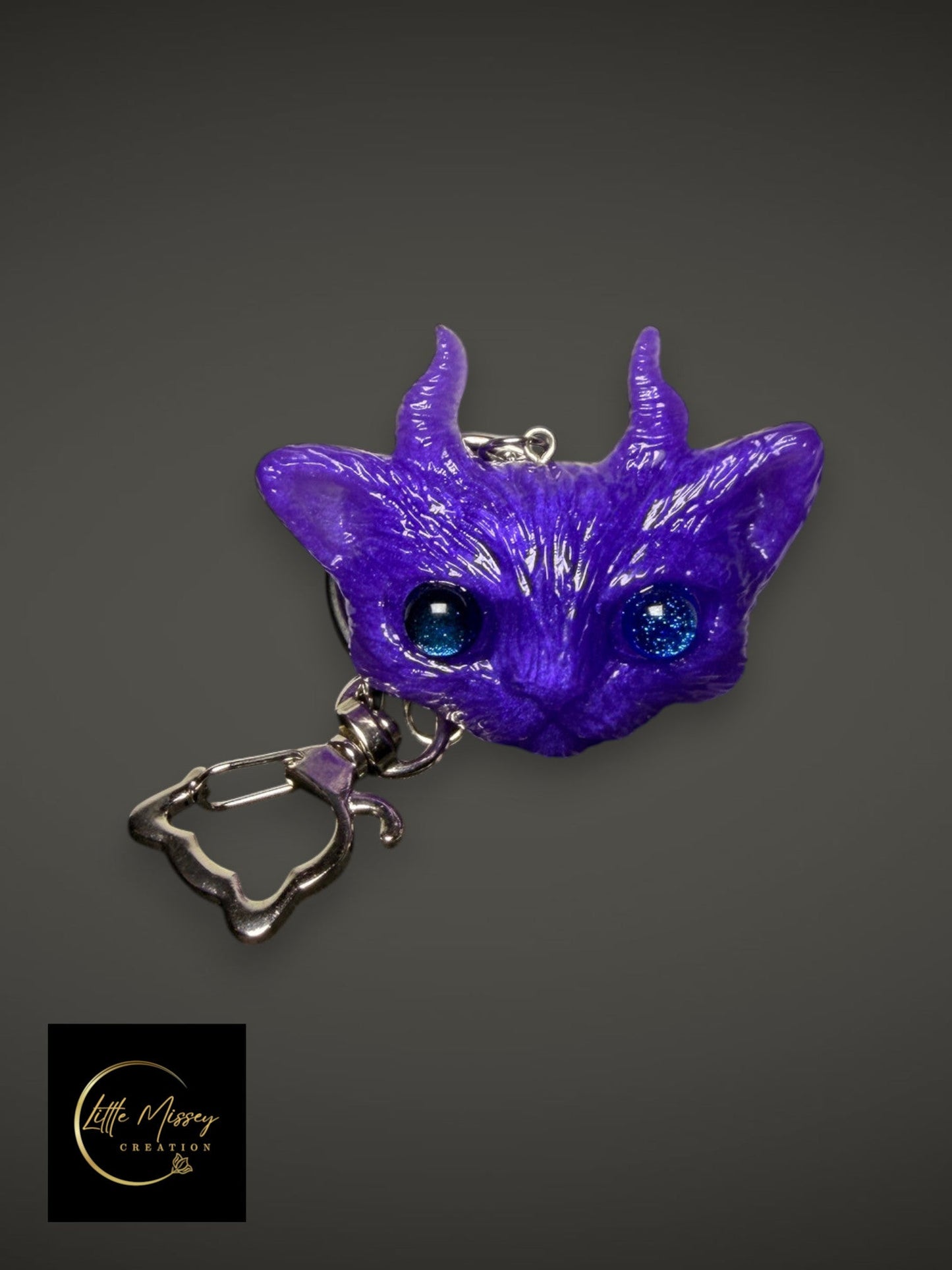 Little Missey Creation purple horned fantasy creature keychain with sparkling blue eyes and a silver metal clasp