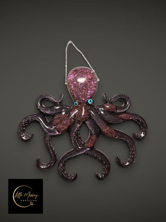 Little Missey Creation purple resin octopus wall hanging with glitter accents and vibrant blue eyes on a grey background