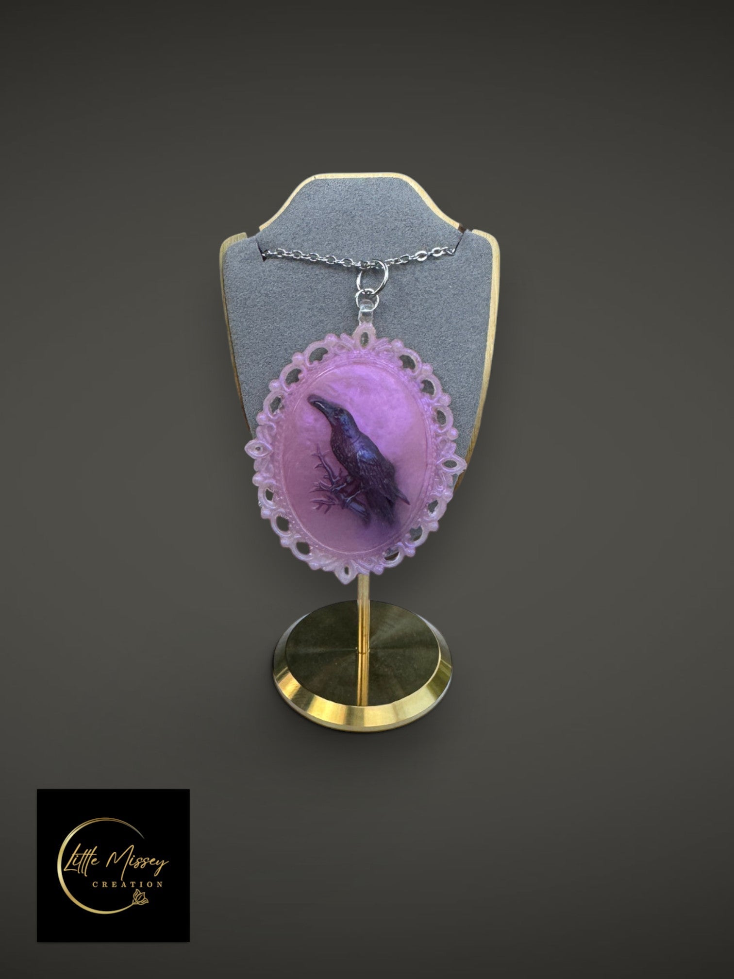 Little Missey Creation raven cameo pendant necklace with a black bird on lavender resin in an ornate silver-tone frame