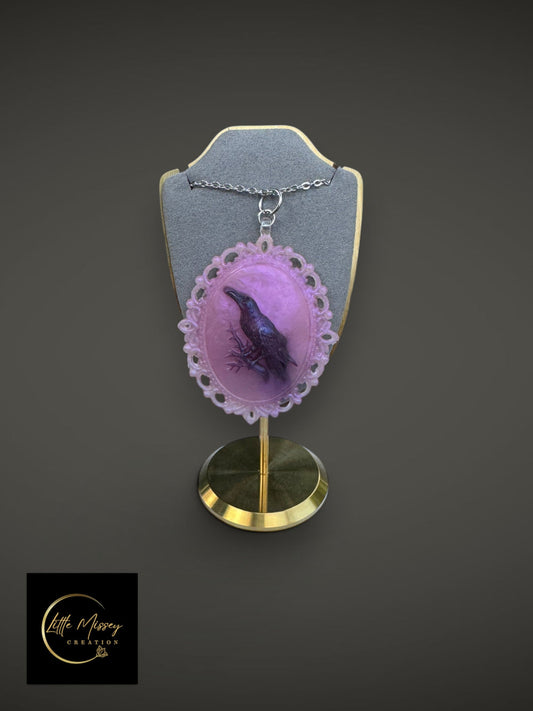 Little Missey Creation raven cameo pendant necklace with a black bird on lavender resin in an ornate silver-tone frame