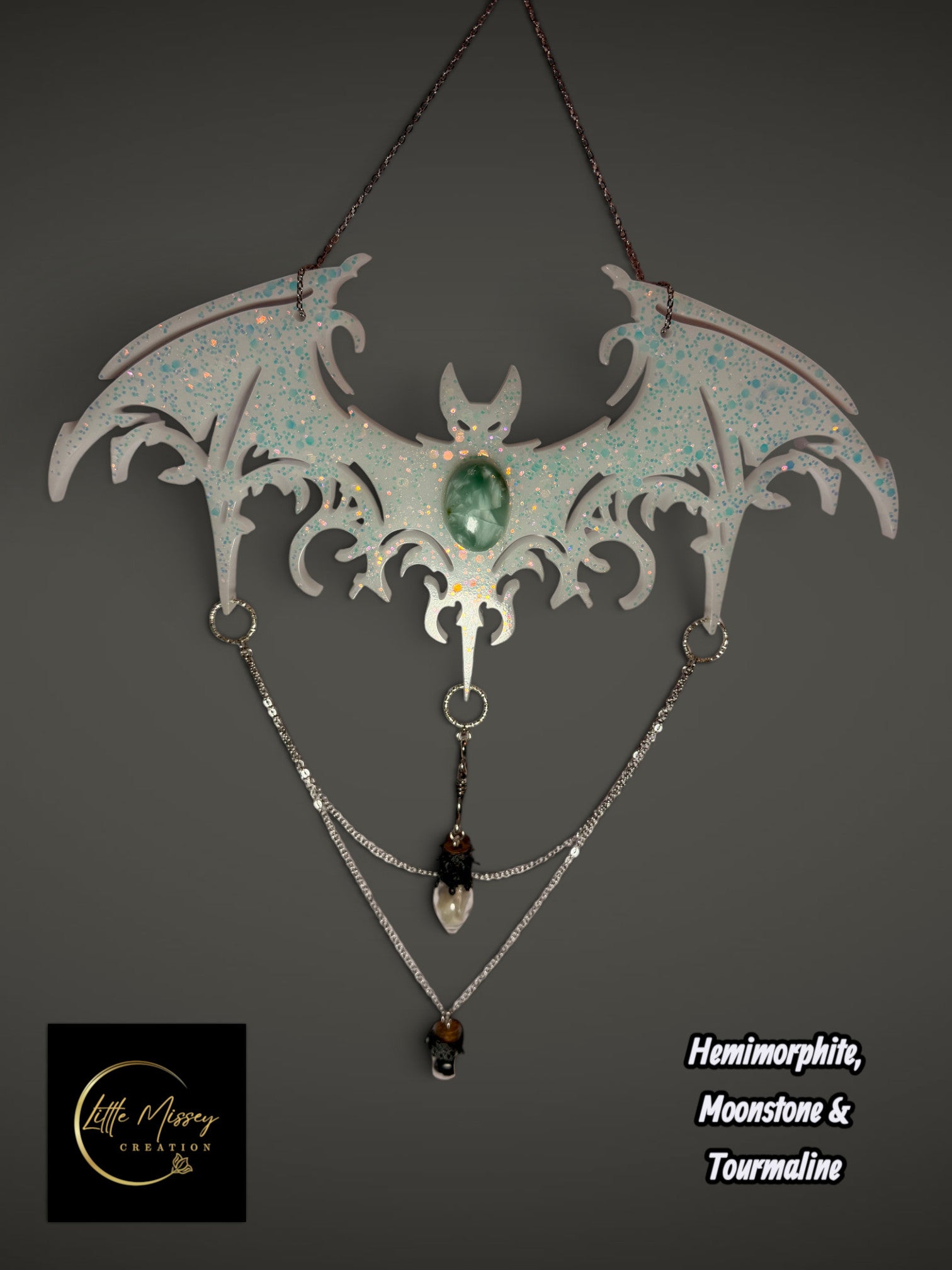 Little Missey Creation handcrafted resin bat wall hanging with iridescent glitter, hemimorphite, moonstone, and chains.
