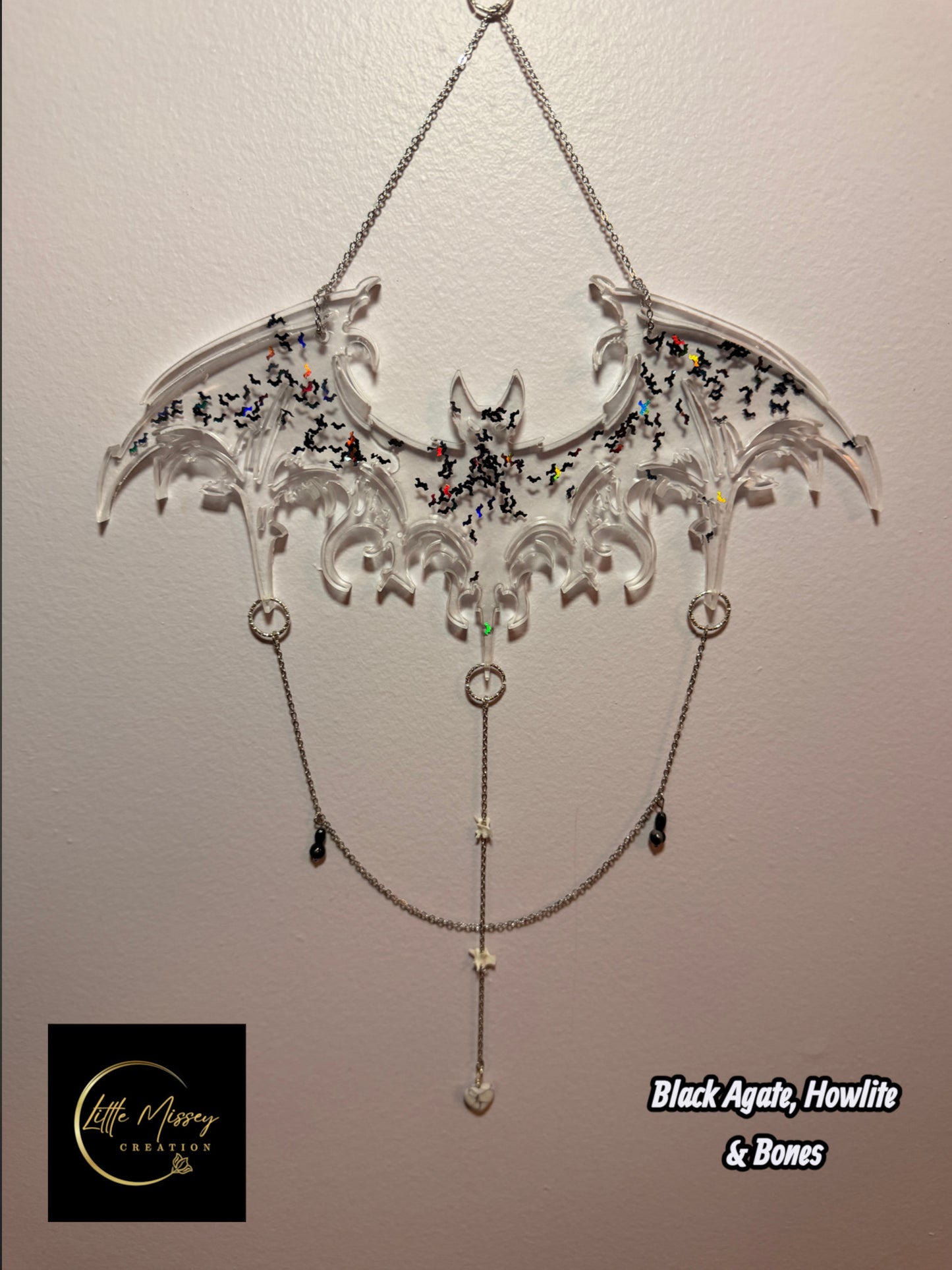 Little Missey Creation handcrafted clear resin bat wall hanging with holographic glitter, metal chains, and bone charms.