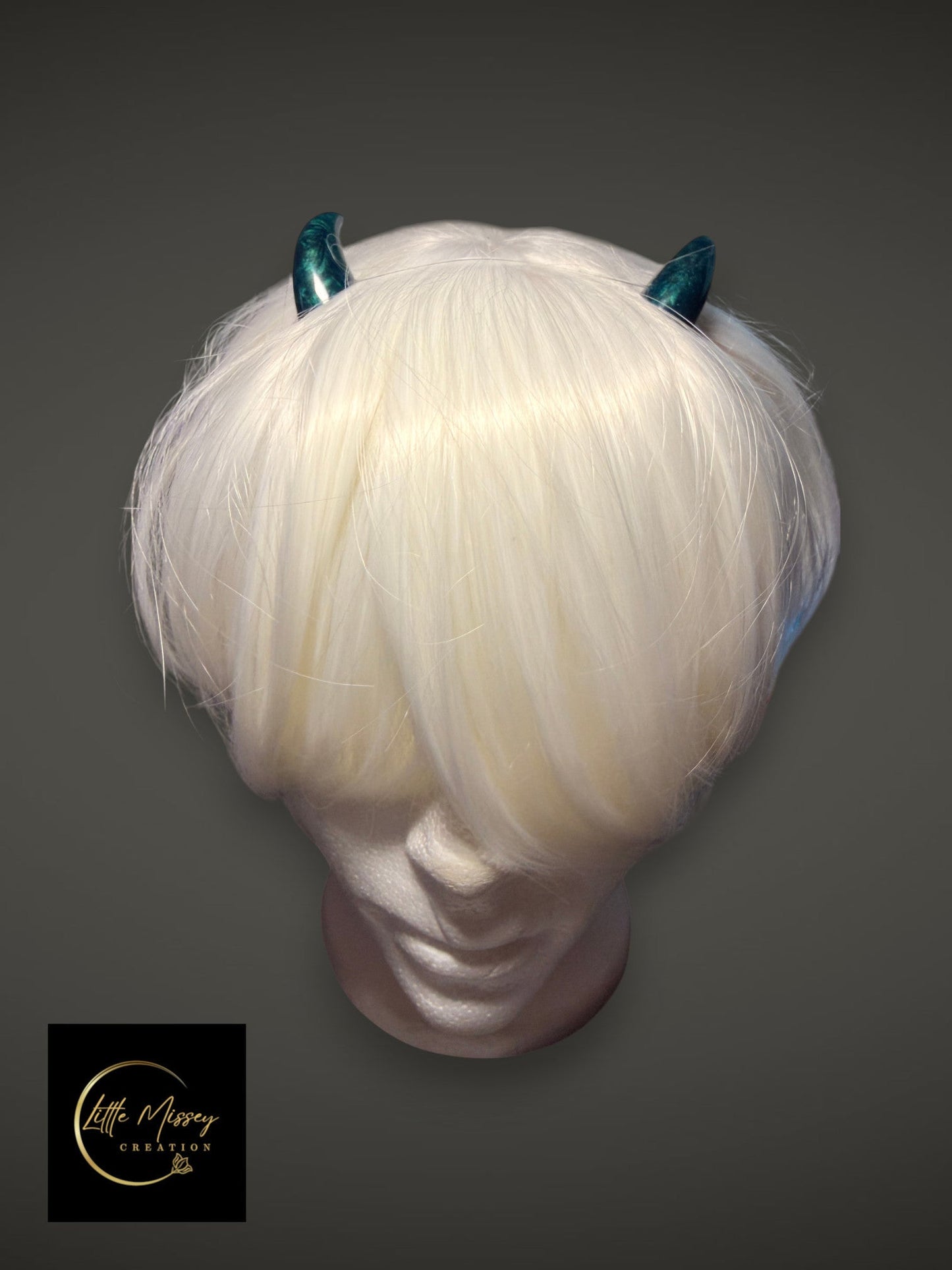 Little Missey Creation handcrafted teal marbled cosplay horns worn on a white wig on a mannequin head
