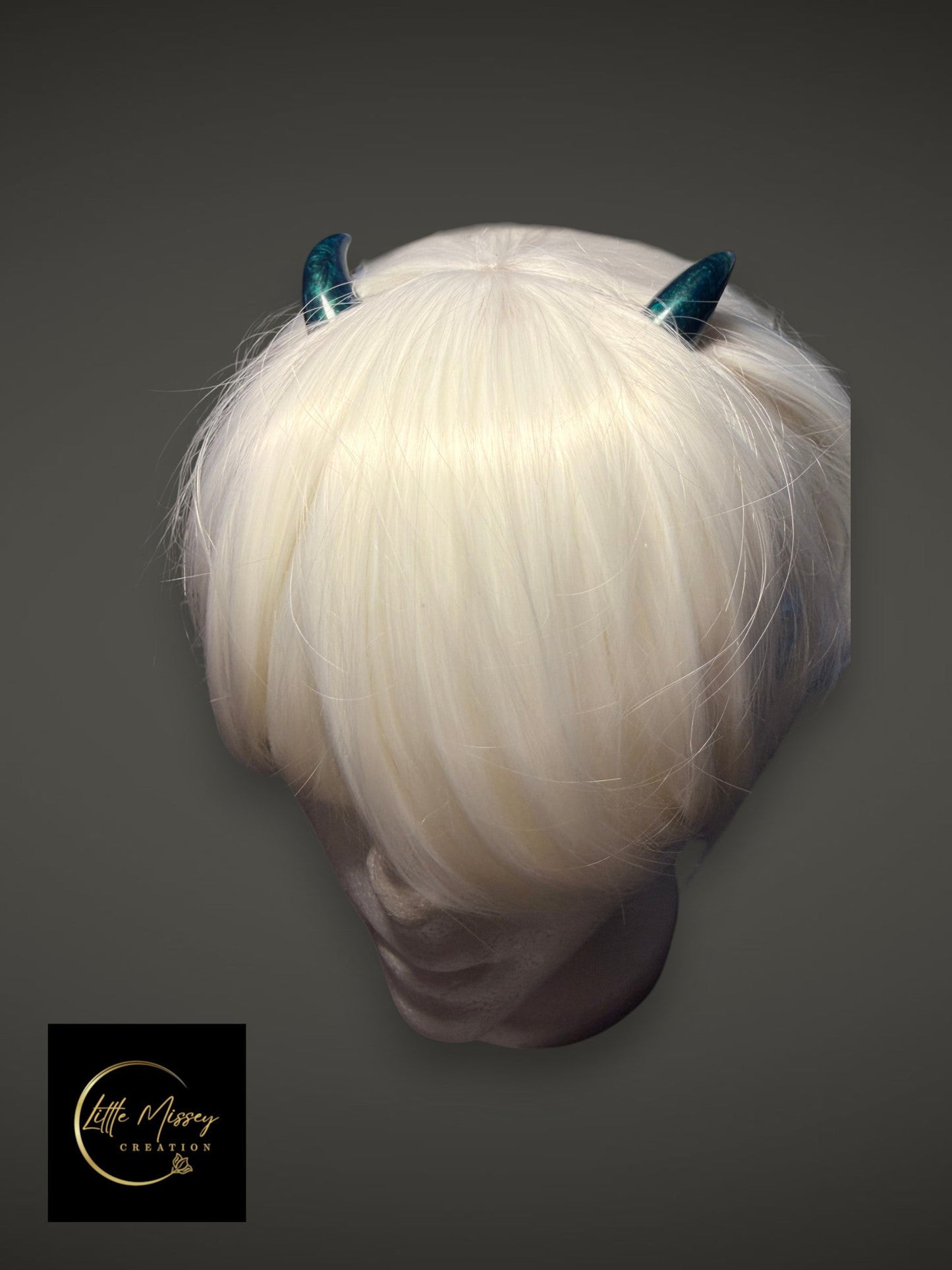 Little Missey Creation teal marbled cosplay horns worn on a white wig, featuring a smooth high-gloss finish.