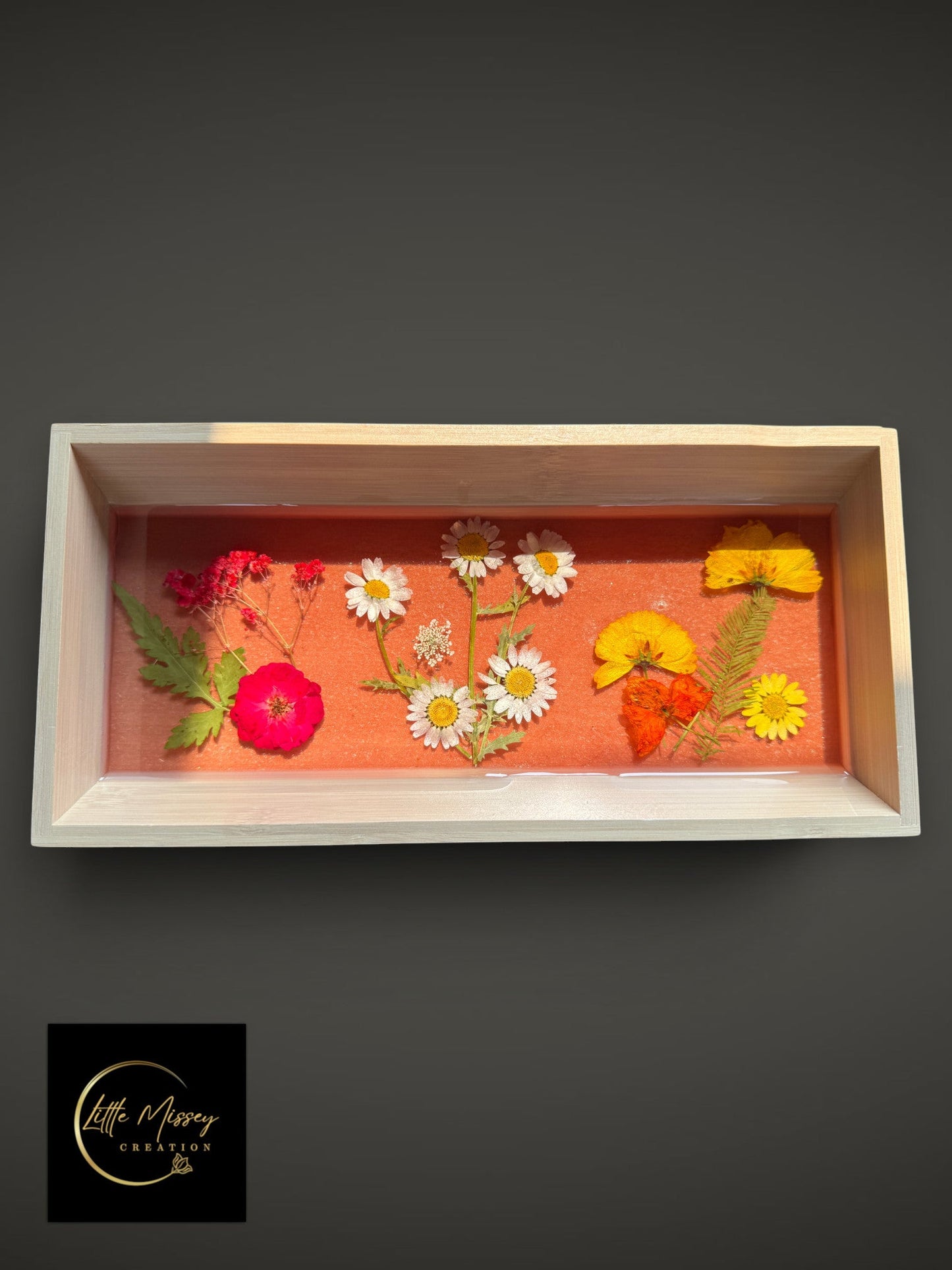 Little Missey Creation rectangular wooden tray with a pink resin base embedded with colorful pressed wildflowers